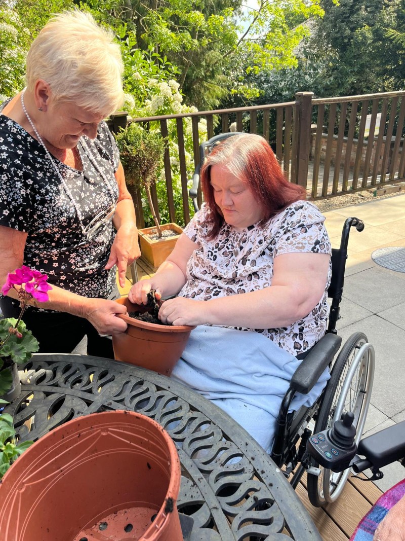 Vickie helping Joy put the new plants in.